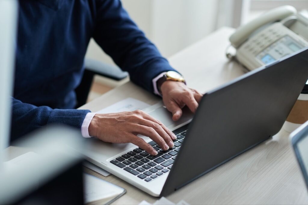 High angle view of employee at work with laptop